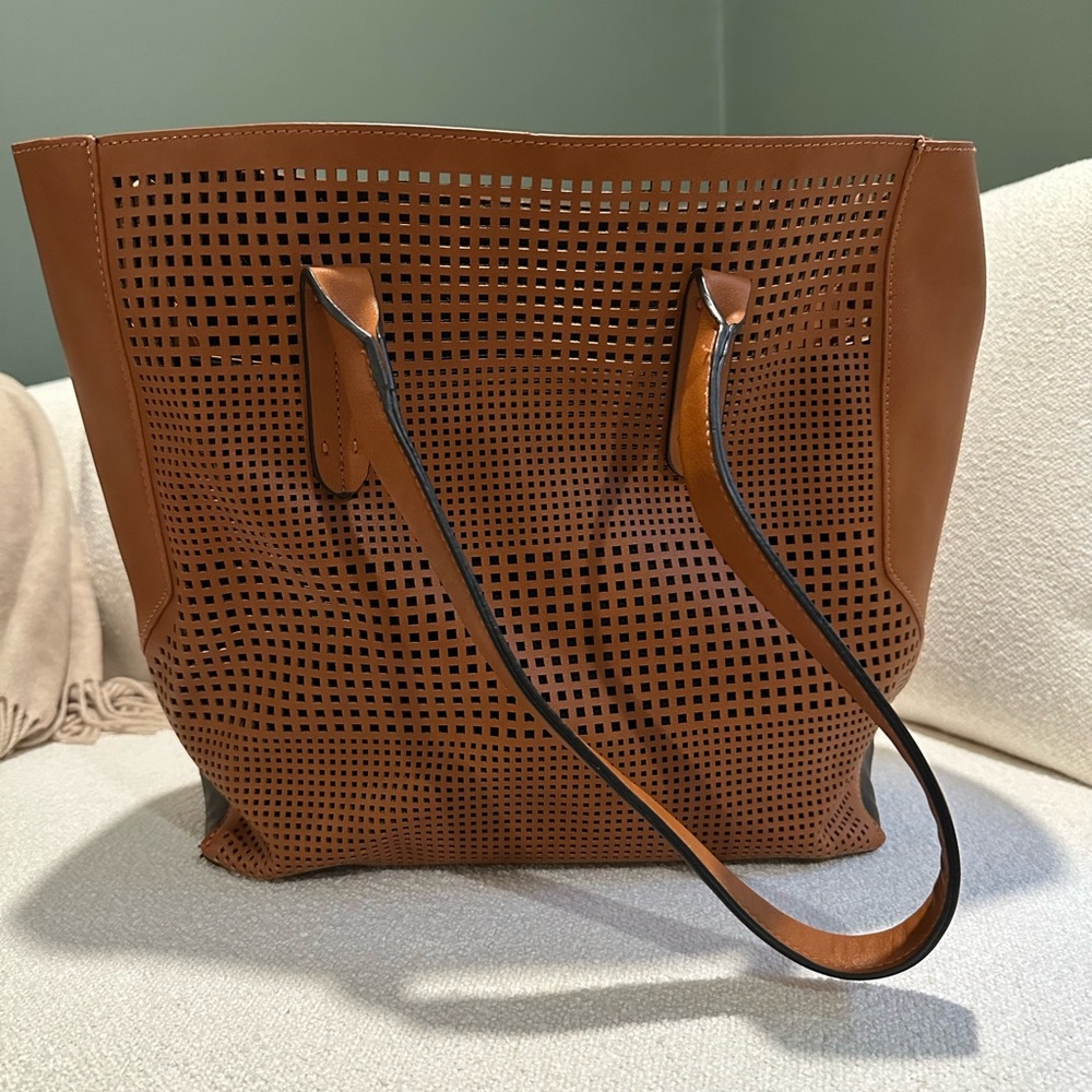 Leather tote with laser cut geometric pattern detailing on front